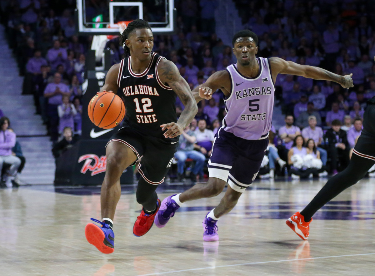 Jan 20, 2024; Manhattan, Kansas, USA; Oklahoma State Cowboys guard Javon Small (12) dribbles by Kansas State Wildcats guard Cam Carter (5) during the second half at Bramlage Coliseum. Mandatory Credit: Scott Sewell-USA TODAY Sports